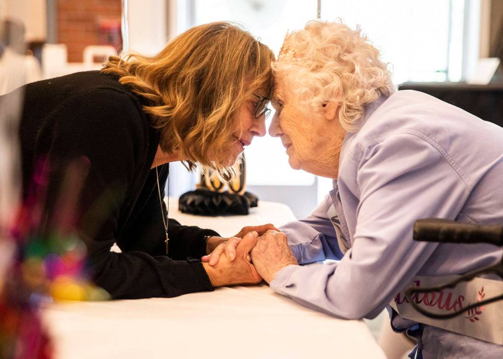 Beverly LaBruyere has a moment with Ferne Ullestad at the party. (Olivia Vanni / The Herald)