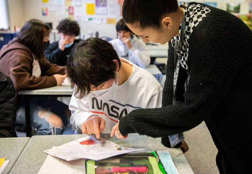 Japanese teacher Alicia Ceban reads a letter with student Ethan Kwon during class at Mariner High School. (Olivia Vanni / The Herald)