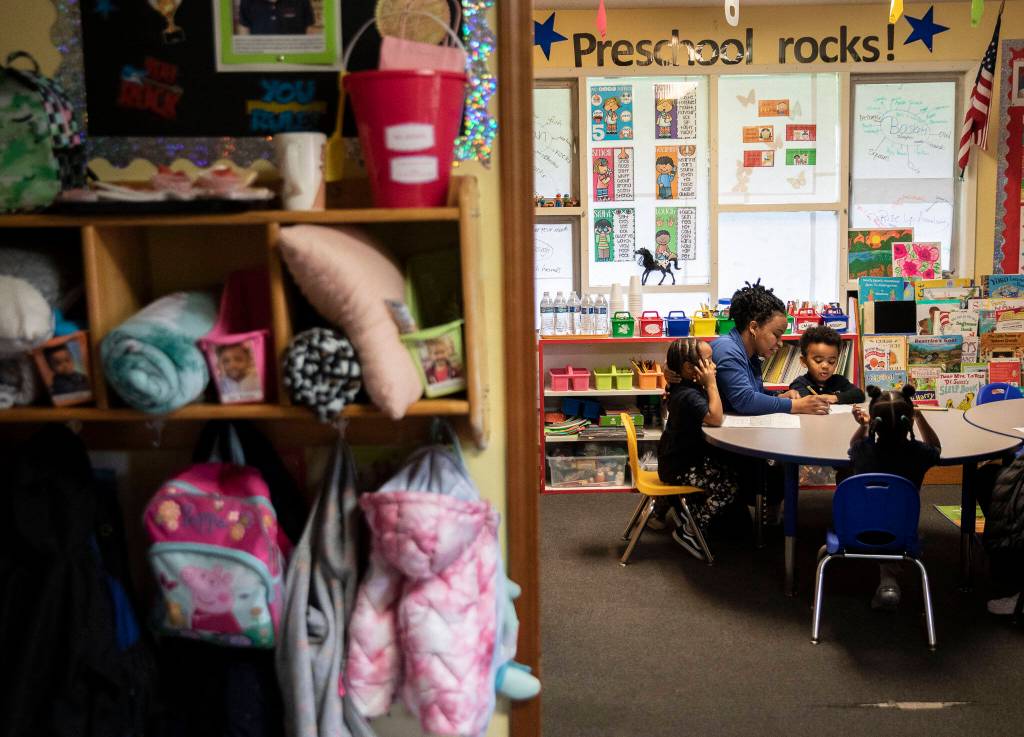 Claire Uwababeyi goes through worksheets with her students during a pre-school class at Greater Trinity Academy on May 3 in Everett. (Olivia Vanni / The Herald)