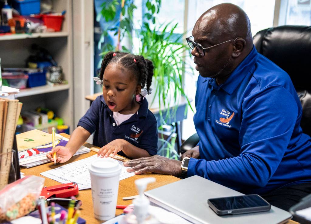 Lexi Green reacts to understanding an addition problem after her teacher Dr. Terry Metcalf walks her through it during kindergarten class at Greater Trinity Academy on May 3 in Everett. (Olivia Vanni / The Herald)
