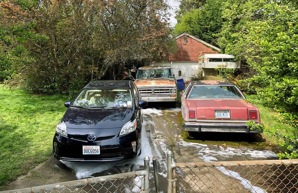 Foam streaked a driveway hours after a fire in a home killed an elderly woman and injured her adult daughter in 2019 in Everett. (Caleb Hutton / The Herald)