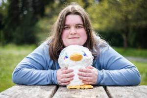 Bailey Hendrickson, owner of Adorable Potato Creations, with one of her specialty plushies called Totally Normal Non Suspicious Duck on Wednesday, May 4, 2022 in Everett, Washington. (Olivia Vanni / The Herald)