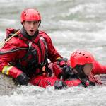 A firefighter calls to shore during the Snohomish Regional Fire Rescues annual Water Rescue Academy in the Skykomish River on Thursday in Index. (Kevin Clark / The Herald)