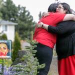 Kyra Isaac (left), artist of The Red Dress Project, and Jennifer Bereskin embrace during a remembrance for missing and murdered Indigenous people at Edmonds Lutheran Church in Edmonds on Wednesday. (Kevin Clark / The Herald)
