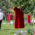 Diana Nielsen browses The Red Dress Project at Edmonds Lutheran Church in Edmonds. (Kevin Clark / The Herald)