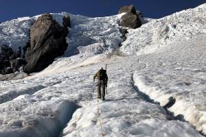Park scientists take measurements on the Olympic Peninsula's Blue and Eel Glaciers in 2018. (Olympic National Park)