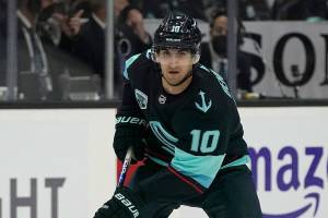 Seattle Kraken center Matty Beniers (10) looks to pass against the San Jose Sharks during the first period of an NHL hockey game, Friday, April 29, 2022, in Seattle. (AP Photo/Ted S. Warren)