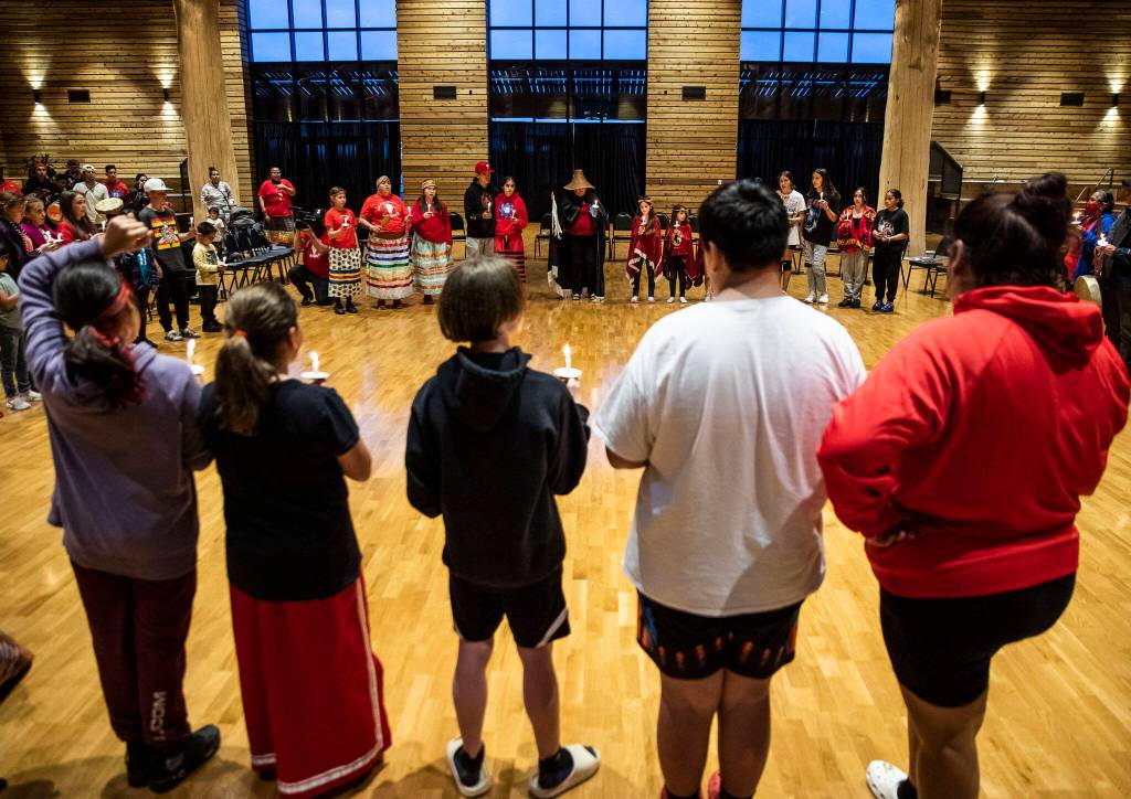 People pause for a moment of silence during a MMIW candlelight vigil at the Tulalip Gathering Hall on Thursday in Tulalip. (Olivia Vanni / The Herald)