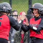 Snohomishs Alli Wilson (left) welcomes teammate Emma Hansen to the plate after Hansen scored a run during a game against Cascade on Thursday afternoon at Phil Johnson Ballfields in Everett. The Panthers won 9-3. (Kevin Clark / The Herald)