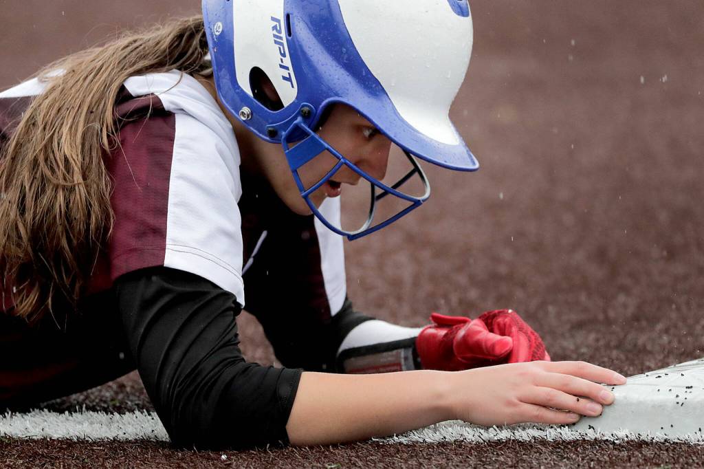 Cascades Allison Gehrig rest at third base after beating a tag attempt against Cascade High School Thursday afternoon at Phil Johnson Ballfields in Everett, Washington on May 5, 2022. The Panthers won 9-3 in a key matchup between two of the top teams in Wesco 3A/2A. (Kevin Clark / The Herald)