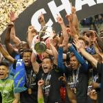 Sounders midfielder Nicolas Lodeiro holds the trophy alongside teammates after defeating Mexicos Pumas to win the CONCACAF Champions League final on Wednesday at Lumen Field in Seattle. (AP Photo/Ted S. Warren)