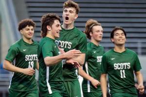 Shorecrests Mason Dougherty, front, is celebrated for a goal against Edmonds-Woodway High School Tuesday evening at Shoreline Stadium in Shoreline, Washington on May 3, 2022. (Kevin Clark / The Herald)