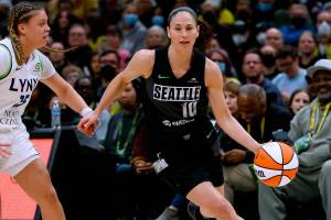 Seattle Storm guard Sue Bird drives around Minnesota Lynx guard Rachel Banham during the first quarter of a WNBA basketball game Friday, May 6, 2022, in Seattle. (Jennifer Buchanan/The Seattle Times via AP)