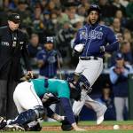 Tampa Bay Rays Yandy Diaz, right, scores on a Randy Arozarena single as Seattle Mariners catcher Tom Murphy recovers the ball during the second inning of a game Friday in Seattle. (AP Photo/Jason Redmond)