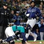 Tampa Bay Rays' Yandy Diaz, right, scores on a Randy Arozarena single as Seattle Mariners catcher Tom Murphy recovers the ball during the second inning of a baseball game Friday, May 6, 2022, in Seattle. (AP Photo/Jason Redmond)