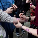 North Middle School students write no means no on their arms during a walkout on Monday. (Olivia Vanni / The Herald)