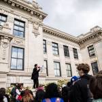 Everett High School student Soren Dellaguardia speaks to a group of students before leading a walkout to North Middle School on Monday in Everett. (Olivia Vanni / The Herald)