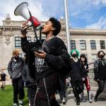 Everett High School student Soren Dellaguardia leads a walkout from the high school to North Middle School on Monday, May 9, 2022 in Everett, Washington. (Olivia Vanni / The Herald)
