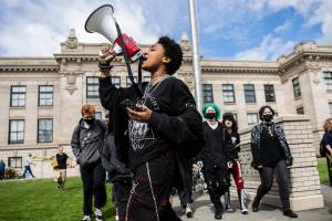 Everett High School student Soren Dellaguardia leads a walkout from the high school to North Middle School on Monday, May 9, 2022 in Everett, Washington. (Olivia Vanni / The Herald)