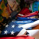 An American flag is seen among dozens of other flags at Melissa Batsons home in Monroe. The two American flags Batson owns were her first two flag purchases. (Ryan Berry / The Herald)
