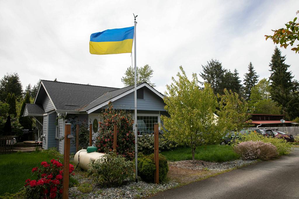 A Ukranian flag flies on the flagpole in front of Melissa Batsons home in Monroe. Batson said she rose the flag in support of Ukraine, and will continue flying it until Memorial Day, when she plans to fly the American flag. (Ryan Berry / The Herald)