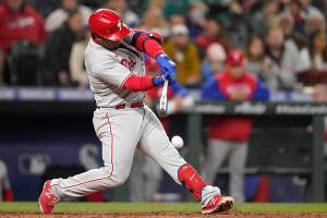 Philadelphia Phillies' Jean Segura hits into a force-out that allowed Nick Castellanos to score from third during the fifth inning of a baseball game against the Seattle Mariners, Monday, May 9, 2022, in Seattle. (AP Photo/Ted S. Warren)