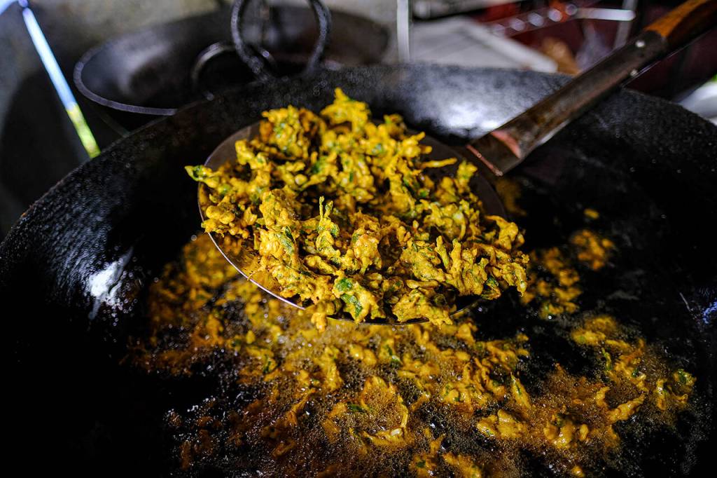 The Food Atlas serves up freshly fried pakora, a spiced veggie fritter that originated in India and will be available at the Fishermans Village Night Market. (Taylor Goebel / The Herald)