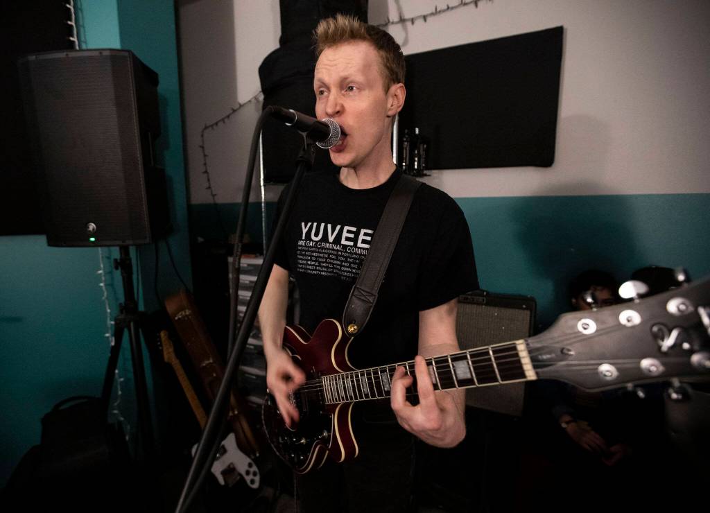 Bad Optics guitarist Christian Smith sings while the band practices May 17 in Everett. (Olivia Vanni / The Herald)