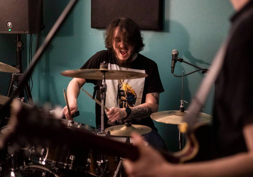 Bad Optics drummer Joshua Ihler practices with the band on May 17 in Everett. (Olivia Vanni / The Herald)