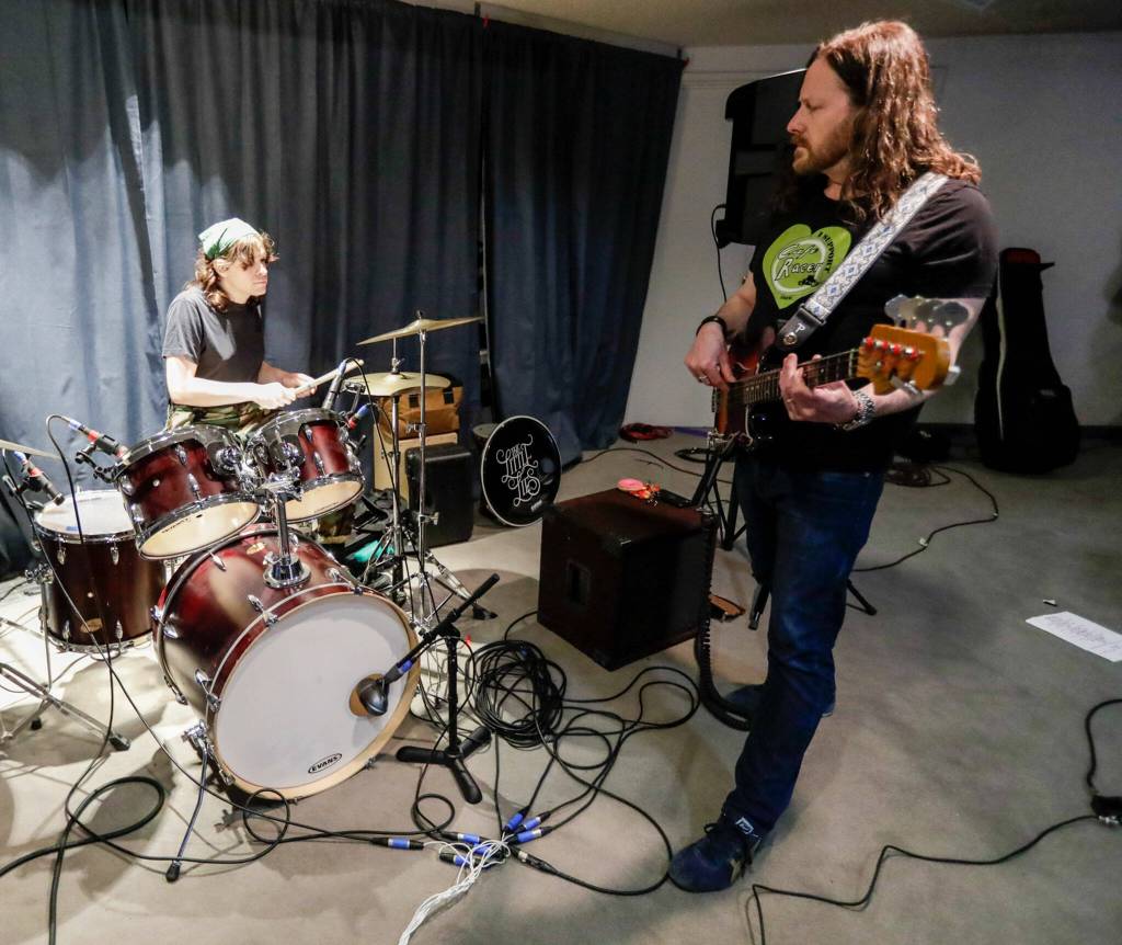 Cyra Wirth (left) and Harry Wirth of The Little Lies rehearse in Everett on May 16. (Kevin Clark / The Herald)