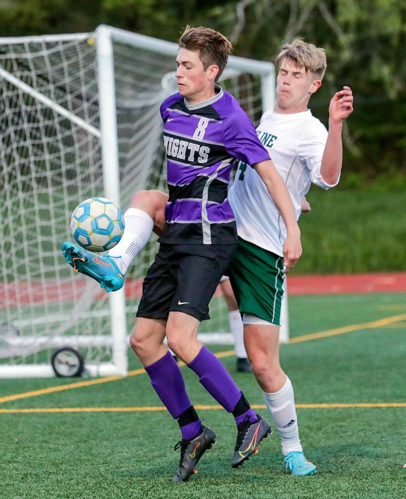 Kamiaks Benjamin Webb attempts to fend off Skylines Micah Pommer Tuesday night at Kamiak High School in Mukilteo. (Kevin Clark / The Herald)
