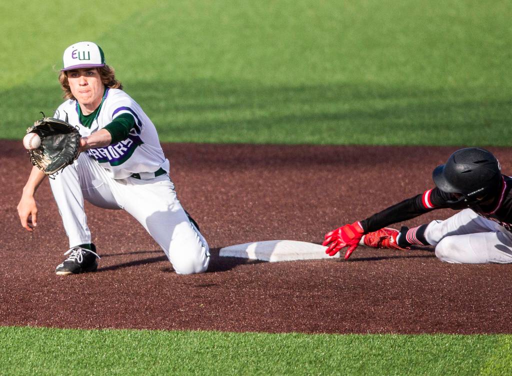 Edmonds-Woodways Grant Oliver reaches for the ball during the district semifinal game at Funko Field on Tuesday in Everett. (Olivia Vanni / The Herald)