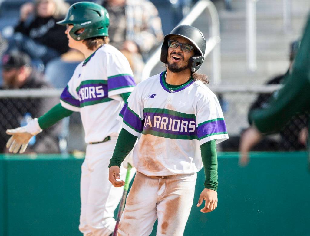 Edmonds-Woodways Nathnuel Marinez reacts to scoring a run during the district semifinal game at Funko Field on Tuesday in Everett. (Olivia Vanni / The Herald)