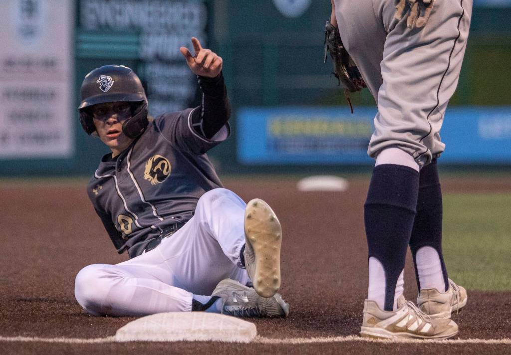 Lynnwoods Mason Lane slides into third base during the district semifinal game at Funko Field on Tuesday in Everett. (Olivia Vanni / The Herald)