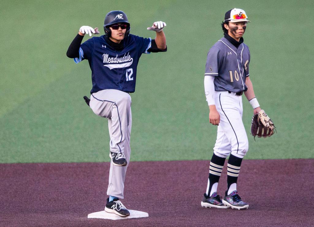 Meadowdales Nicholas Banez poses on second base after hitting a double during the district semifinal game at Funko Field on Tuesday in Everett. (Olivia Vanni / The Herald)