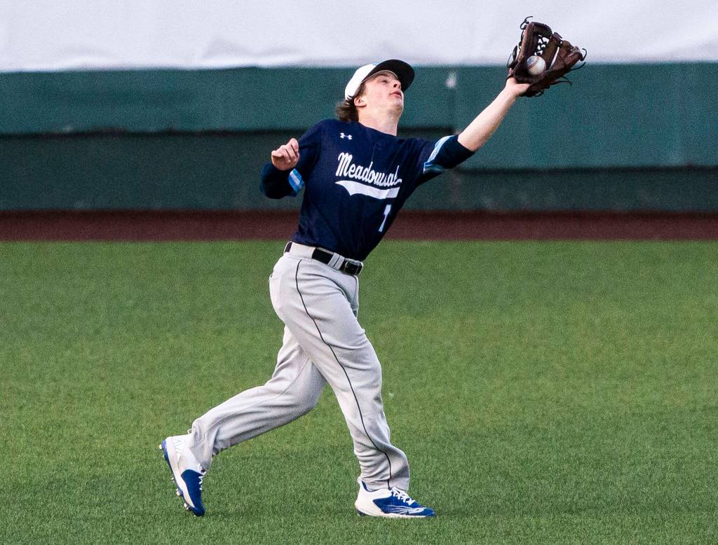 Meadowdales Nicholas Blas makes a catch in the outfield during the district semifinal game at Funko Field on Tuesday in Everett. (Olivia Vanni / The Herald)