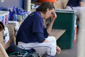 Seattle Mariners starting pitcher Logan Gilbert sits in the dugout after the top of the fourth inning of a baseball game after he gave up a grand slam to Philadelphia Phillies' Rhys Hoskins, Wednesday, May 11, 2022, in Seattle. (AP Photo/Ted S. Warren)