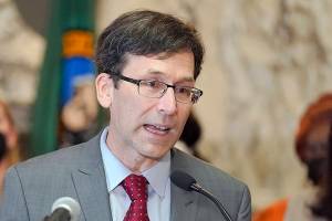 FILE - Washington Attorney General Bob Ferguson speaks March 23, 2022, at the Capitol in Olympia, Wash. Months into a complex trial over their role in flooding Washington with highly addictive painkillers, the nation's three largest opioid distributors have agreed to pay the state $518 million. Ferguson announced the deal Tuesday, May 3, 2022. (AP Photo/Ted S. Warren, File)