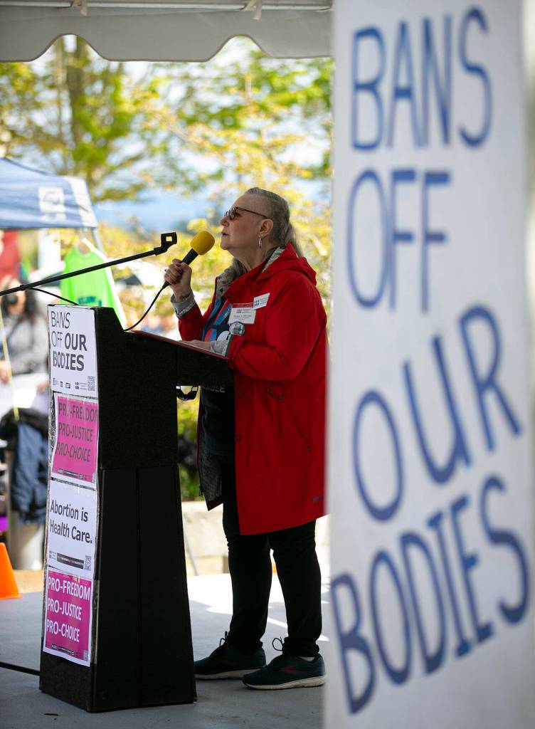 Naomi Dietrich of Snohomish County Indivisible greets a crowd of a few hundred during Snohomish Countys Bans Off Our Bodies rally Saturday, May 14, 2022, outside the county courthouse in Everett, Washington. (Ryan Berry / The Herald)