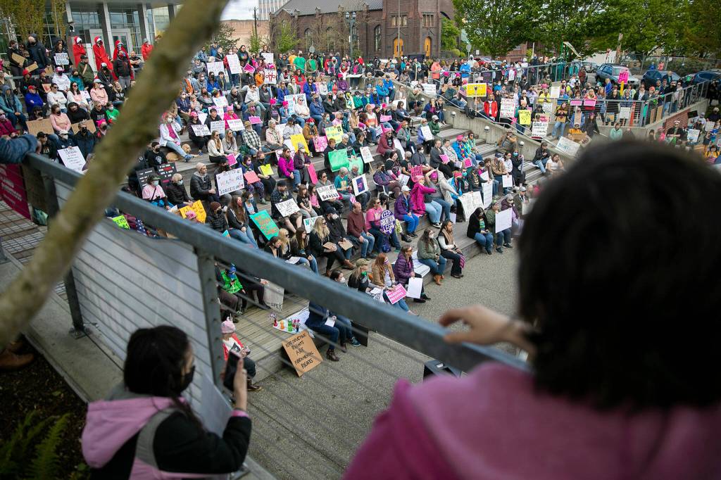 Hundreds of people gather and await the beginning of Snohomish Countys Bans Off Our Bodies rally Saturday, May 14, 2022, outside the county courthouse in Everett, Washington. (Ryan Berry / The Herald)