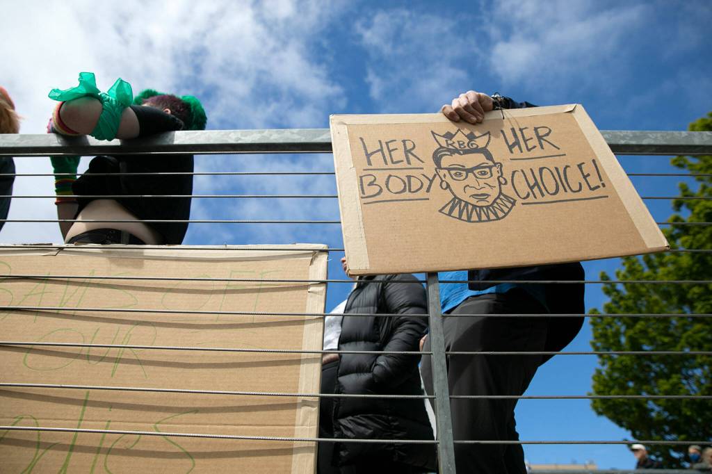 A man holds a pro-abortion rights sign during Snohomish Countys Bans Off Our Bodies rally Saturday, May 14, 2022, outside the county courthouse in Everett, Washington. (Ryan Berry / The Herald)