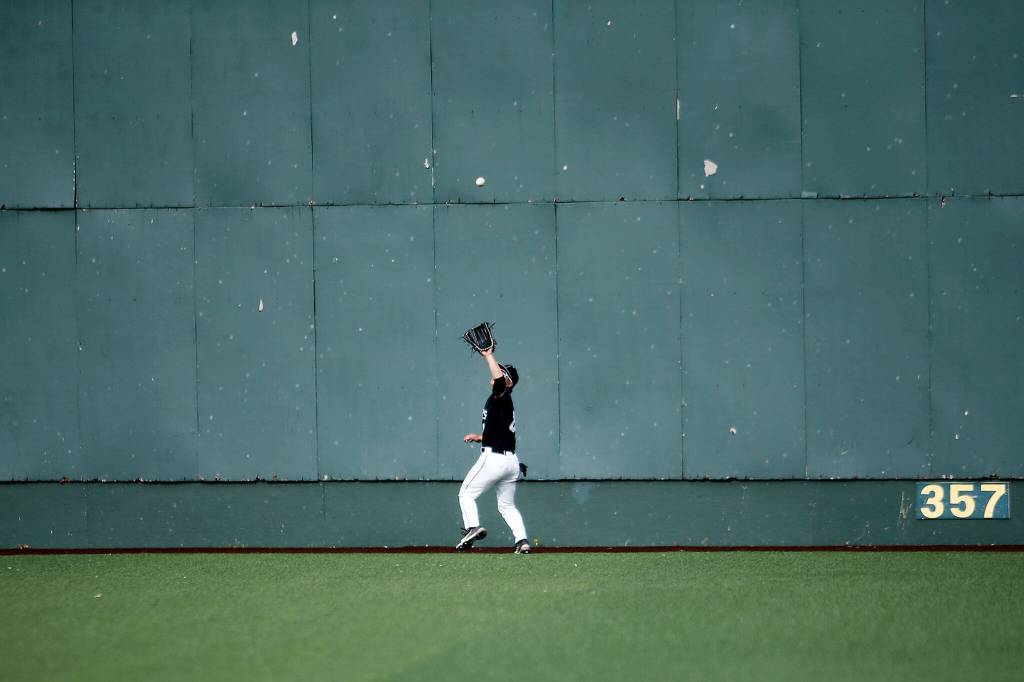 Jacksons Hunter Komine tracks a deep fly ball to the wall against Bothell Friday, May 13, 2022, at Funko Field in Everett, Washington. (Ryan Berry / The Herald)
