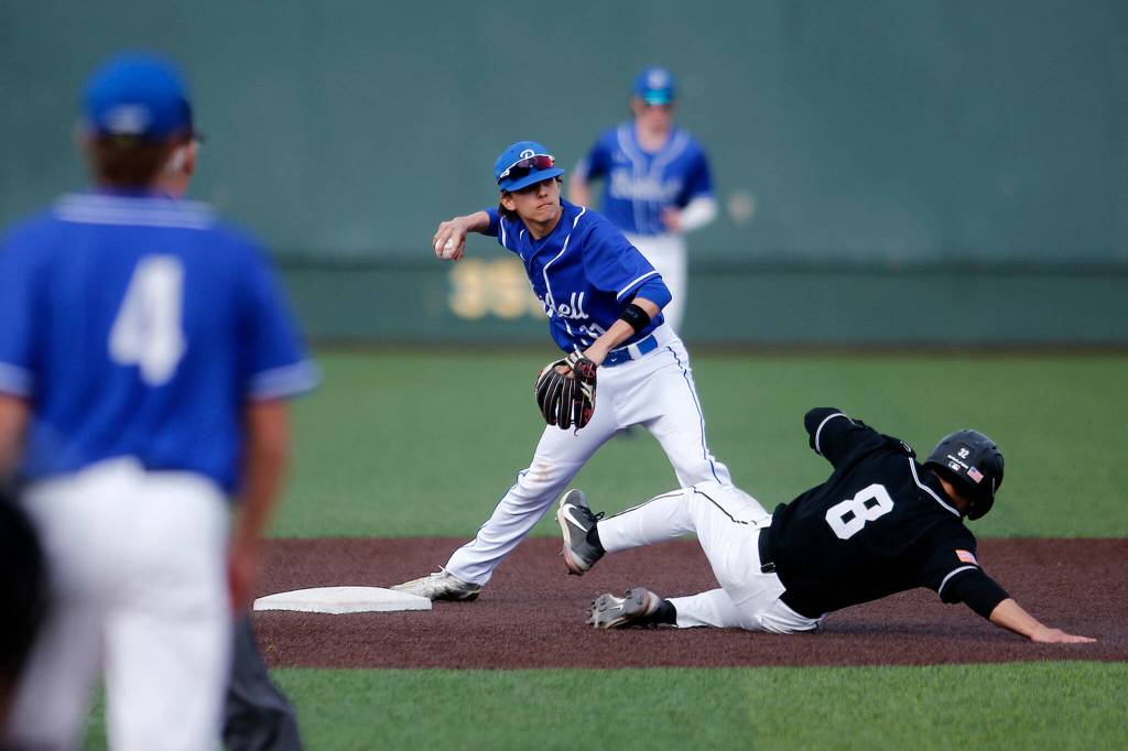 Bothells Trenton Jones looks to turn two before holding onto the ball against Jackson Friday, May 13, 2022, at Funko Field in Everett, Washington. (Ryan Berry / The Herald)