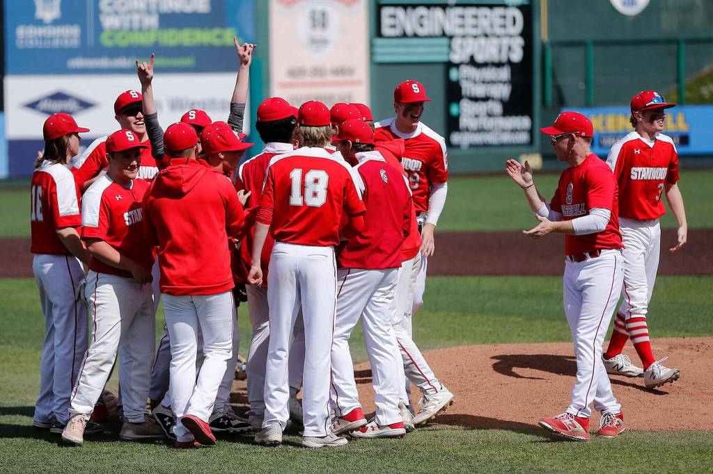 Stanwood players gather at the mound to celebrate their victory over Meadowdale Saturday, May 14, 2022, during a 3A district matchup at Funko Field in Everett, Washington. (Ryan Berry / The Herald)
