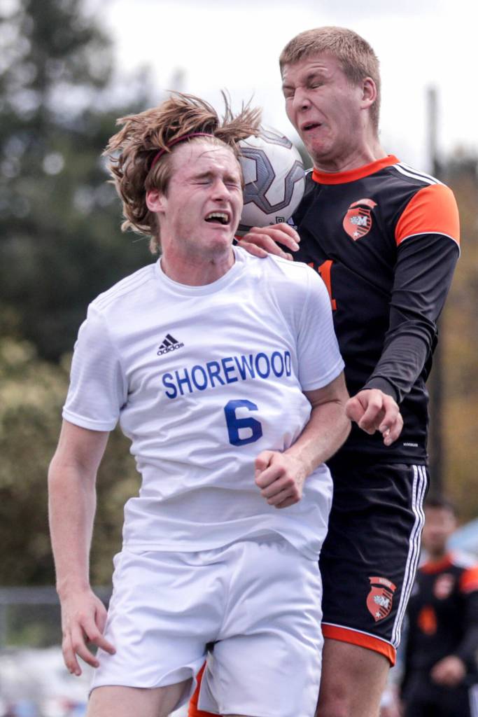 Shorewoods Mason Lucero, left and Monroes Reid Schaeffer jump for a header Saturday afternoon at Shoreline Stadium in Shoreline, Washington on May 14, 2022. The Bearcats won 2-0. (Kevin Clark / The Herald)