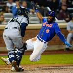 The Mets Starling Marte (right), slides past Mariners catcher Luis Torrens to score on a double by Pete Alonso during the fifth inning of a game Saturday in New York. (AP Photo/Frank Franklin II)