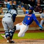 New York Mets' Starling Marte, right, slides past Seattle Mariners catcher Luis Torrens to score on a double by Pete Alonso during the fifth inning of a baseball game Saturday, May 14, 2022, in New York. (AP Photo/Frank Franklin II)