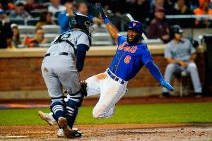 New York Mets' Starling Marte, right, slides past Seattle Mariners catcher Luis Torrens to score on a double by Pete Alonso during the fifth inning of a baseball game Saturday, May 14, 2022, in New York. (AP Photo/Frank Franklin II)