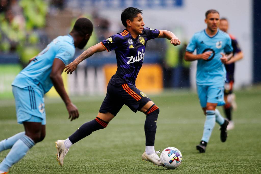 Seattle Sounders Raúl Ruidíaz weaves his way through traffic while looking to cross against Minnesota United Sunday at Lumen Field in Seattle. (Ryan Berry / The Herald)