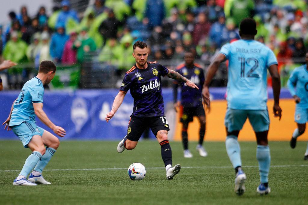 Seattle Sounders Albert Rusnák sends the ball up to a teammate against Minnesota United Sunday at Lumen Field in Seattle. (Ryan Berry / The Herald)